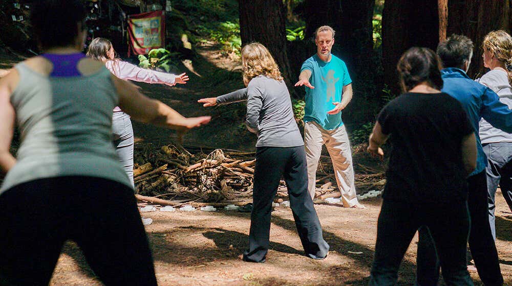 Students follow along with Lee as he teaches in the redwoods.