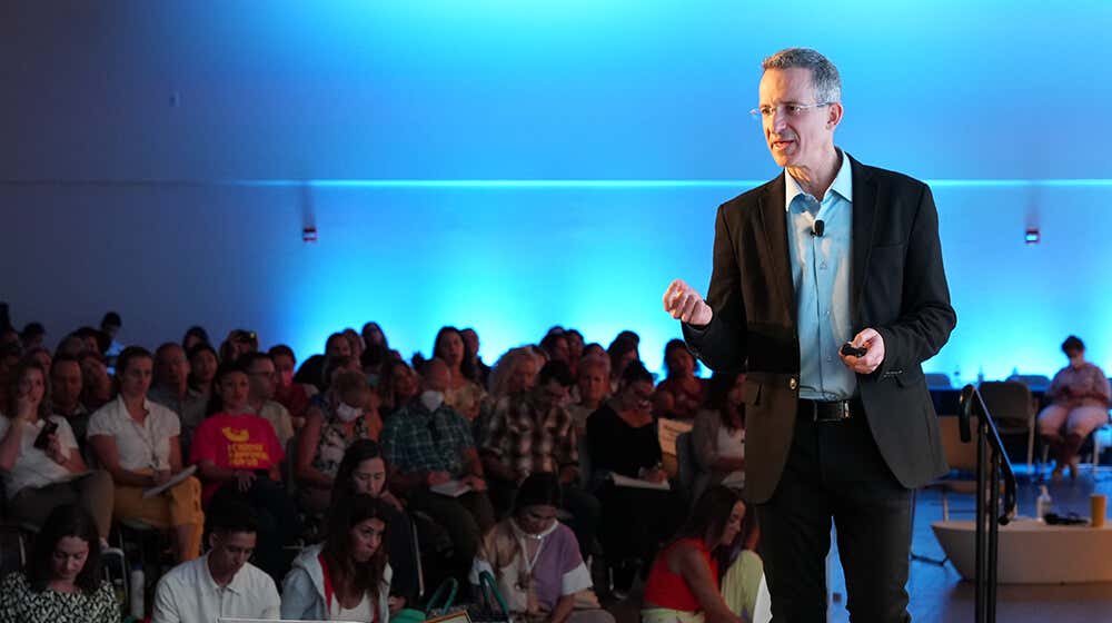 Tal on stage teaching the mindful way to happiness.