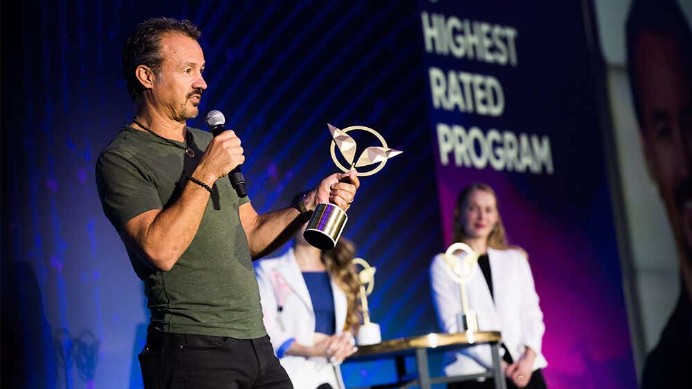 Eric on stage receiving a Mindvalley award