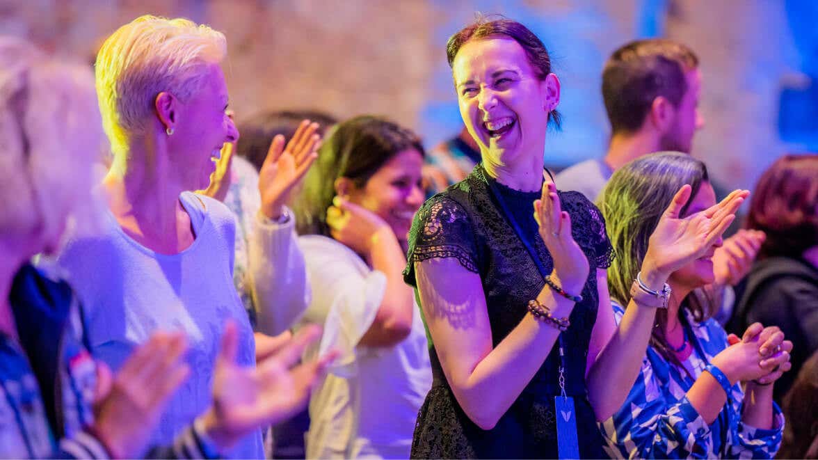 Women clapping hands, smiling happily