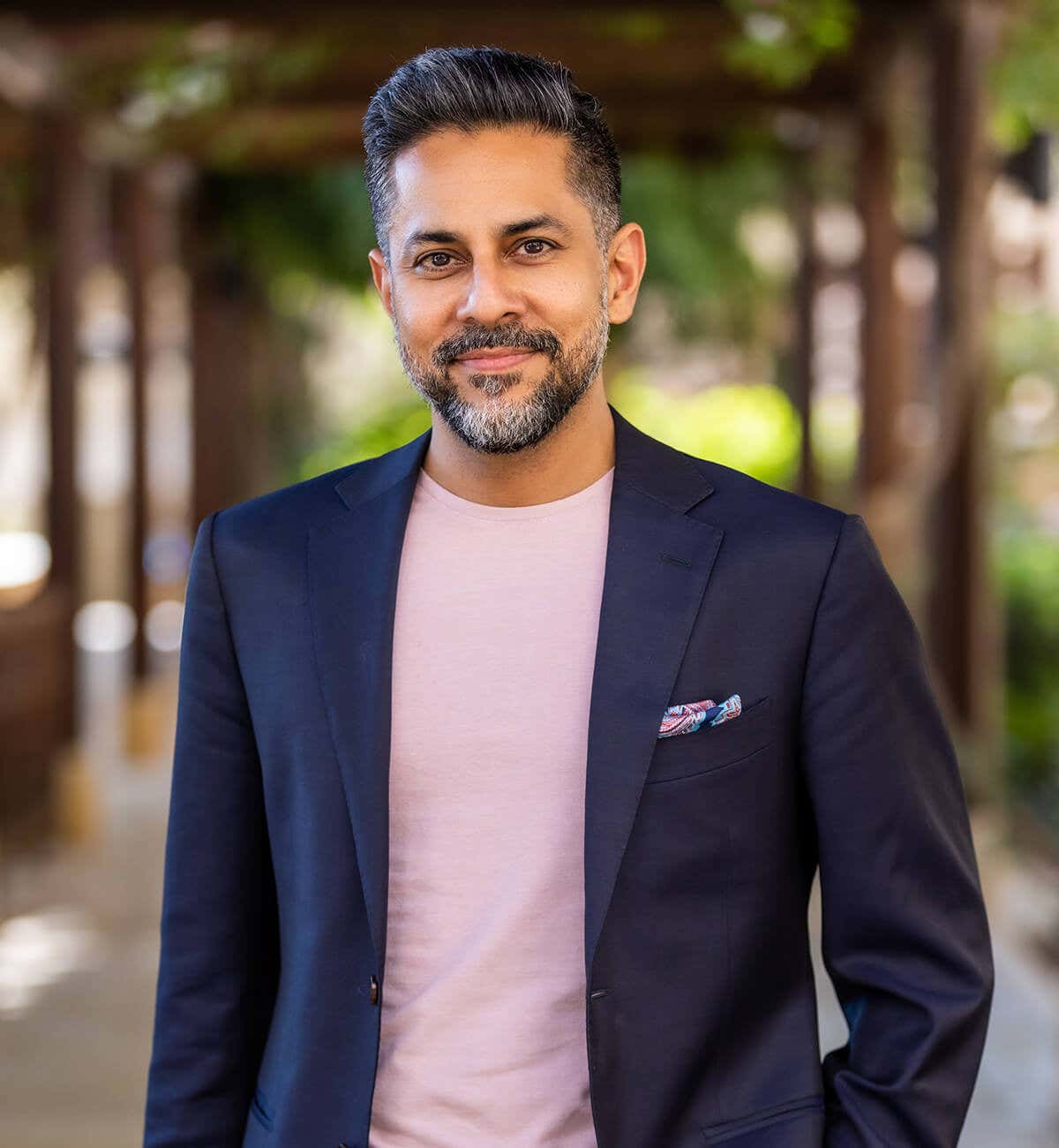 Vishen wearing a light pink t-shirt with a dark blue blazer