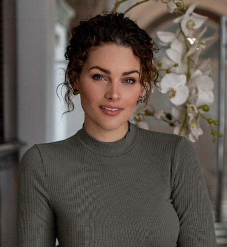 Rolene wearing a sage colored mock neck.