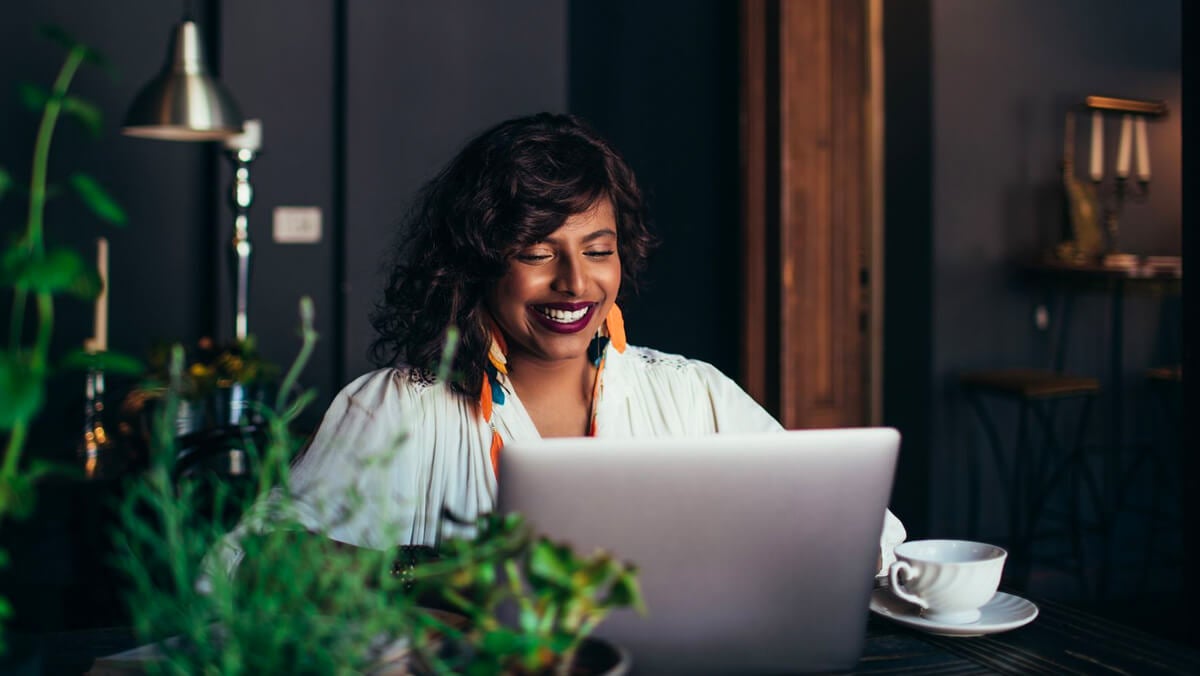 Female Student smiling in front of laptop