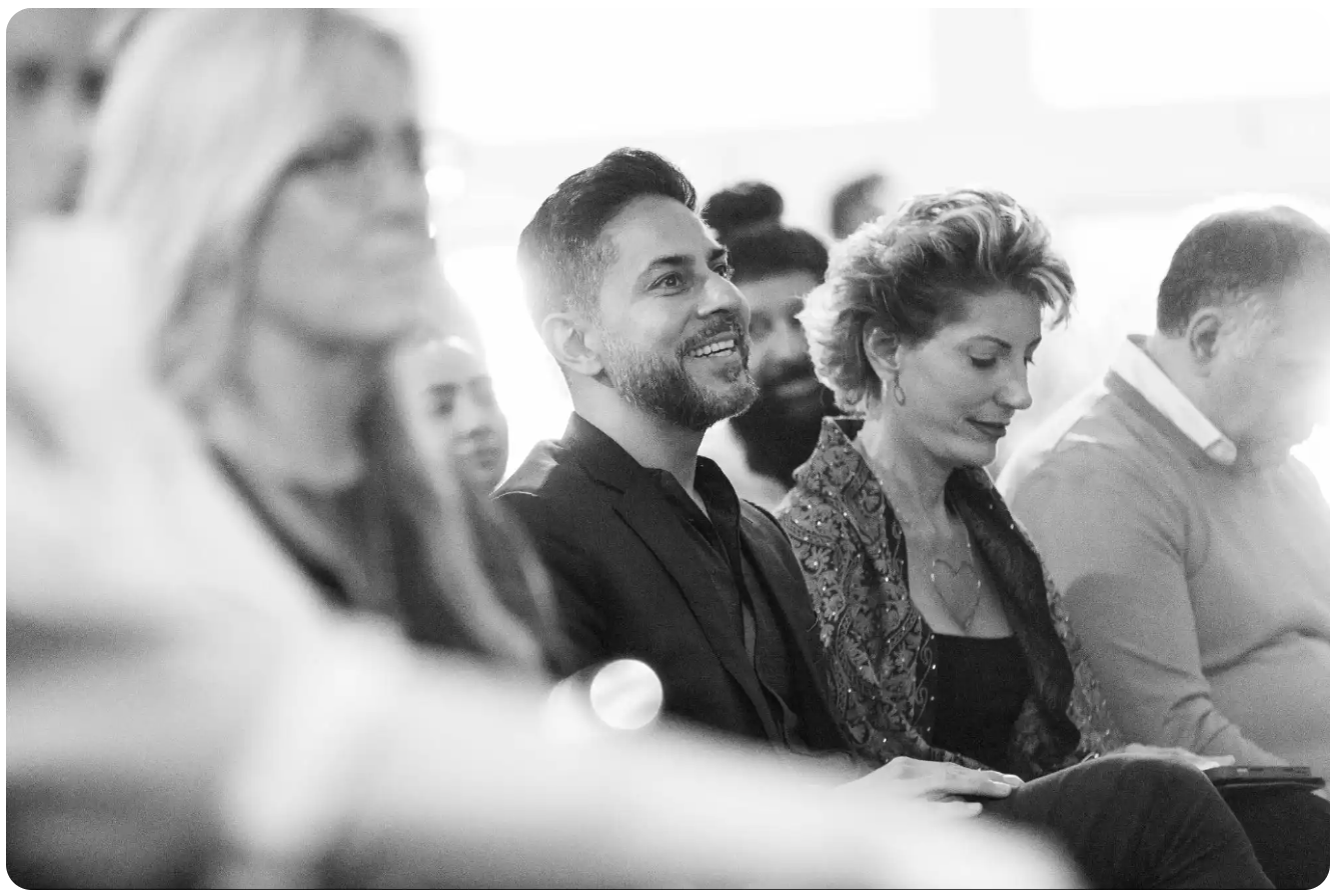 Vishen Lakhiani watching someone speak at the stage