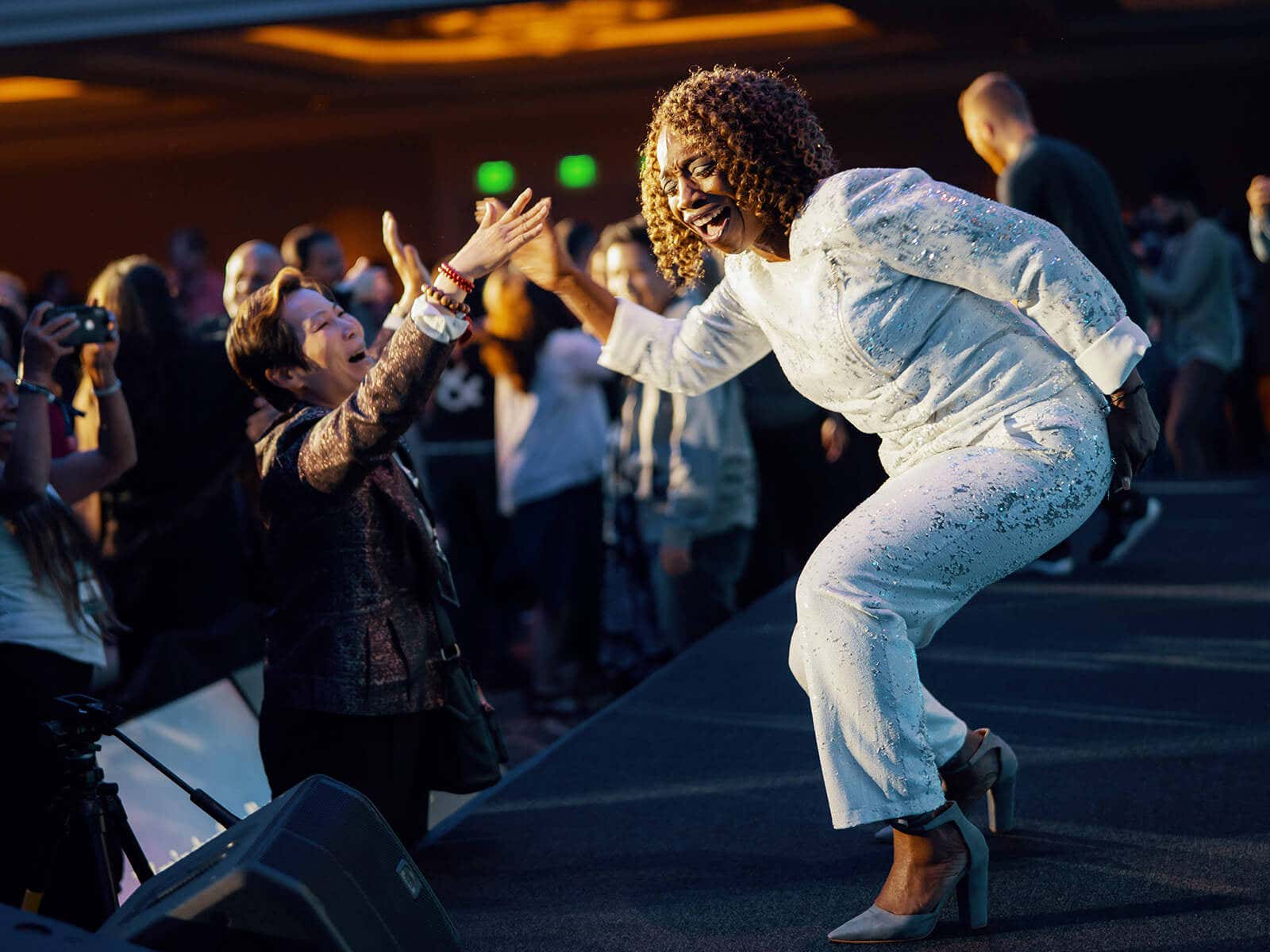 Lisa Nichols on stage giving a high-five