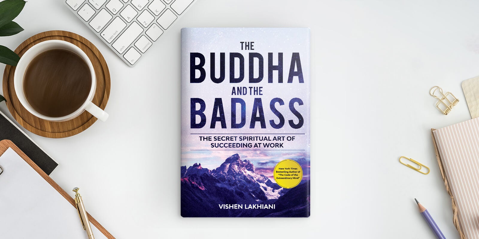 The Buddha and the Badass book on a desk with computer keyboard and notebook