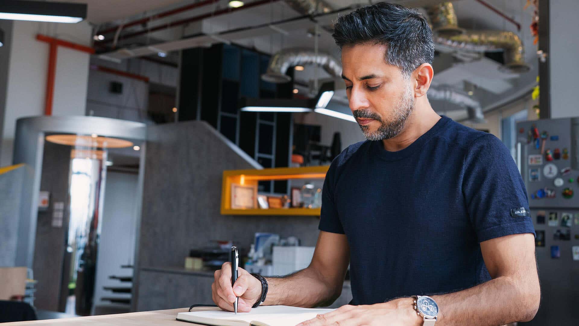 Vishen writing his notes in the office