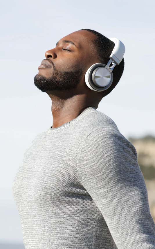 Young man writing and laughing