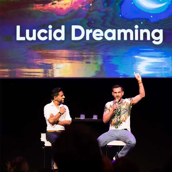 Vishen Lakhiani and Charlie Morley on stage at a Mindvalley event
