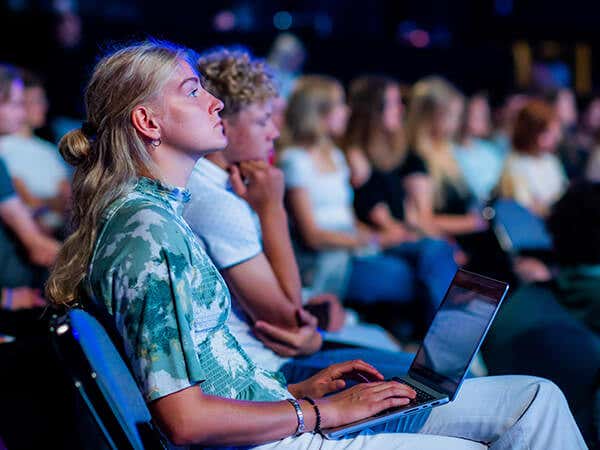 Woman typing on laptop during workshop