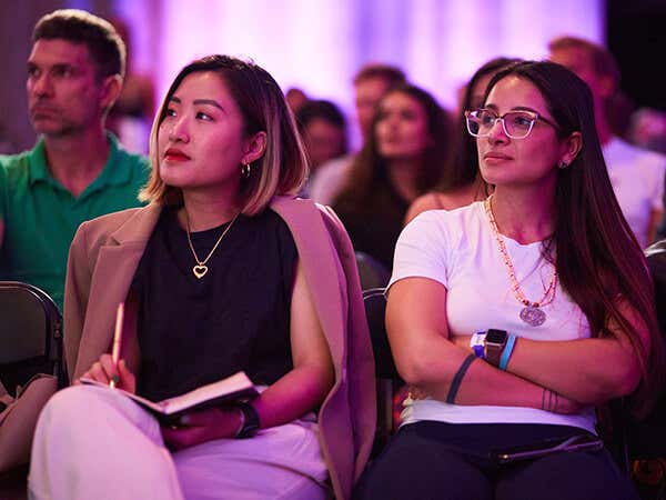 Mindvalley members in workshop listening to talks