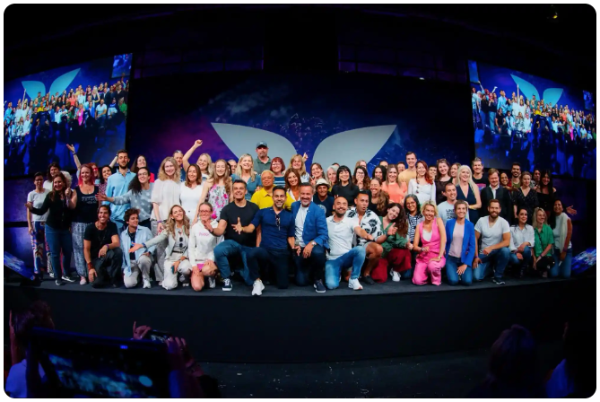 Vishen and Eric Edmeades at a Mindvalley University stage with the WILDFIT community