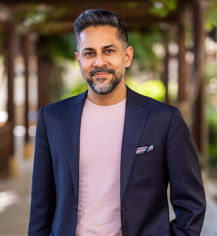 Vishen wearing a light pink t-shirt with a dark blue blazer