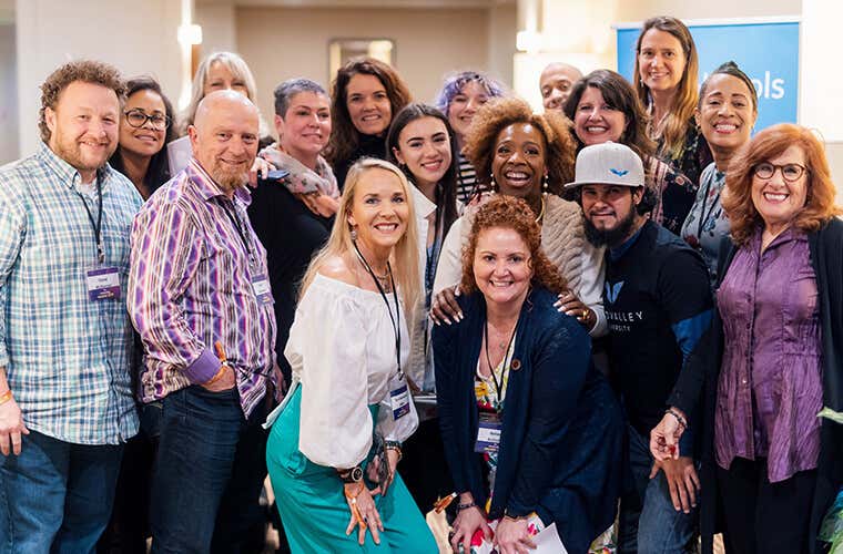 A group of people posing with Lisa Nichols