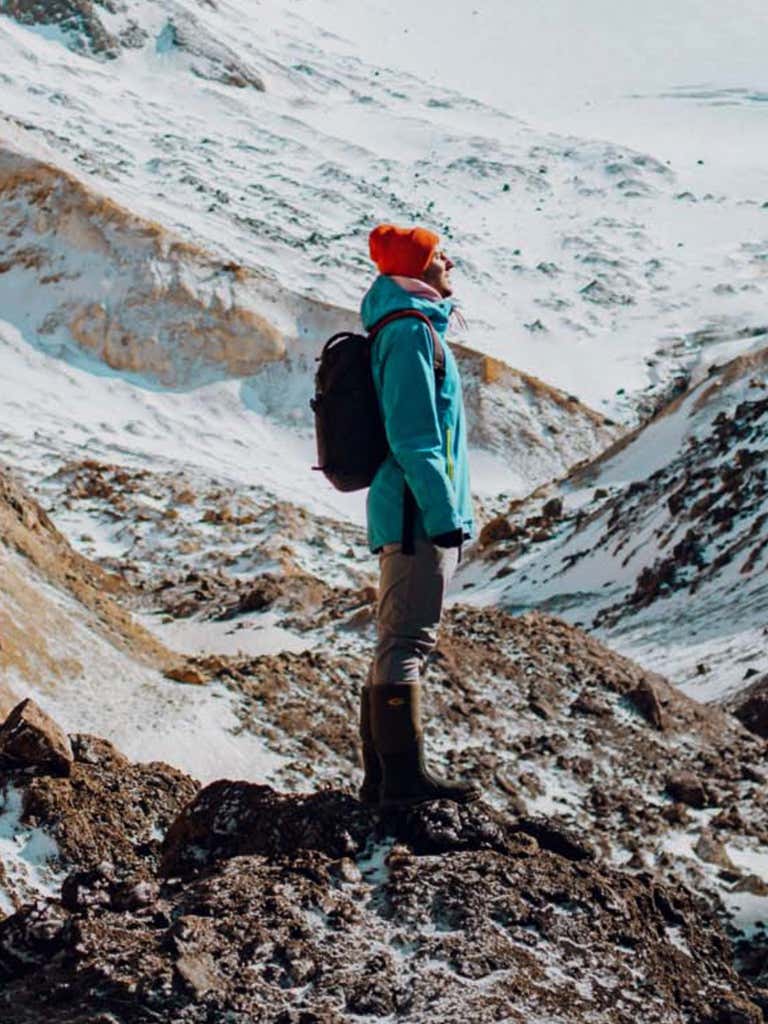 A person staring at the sky in the mountains