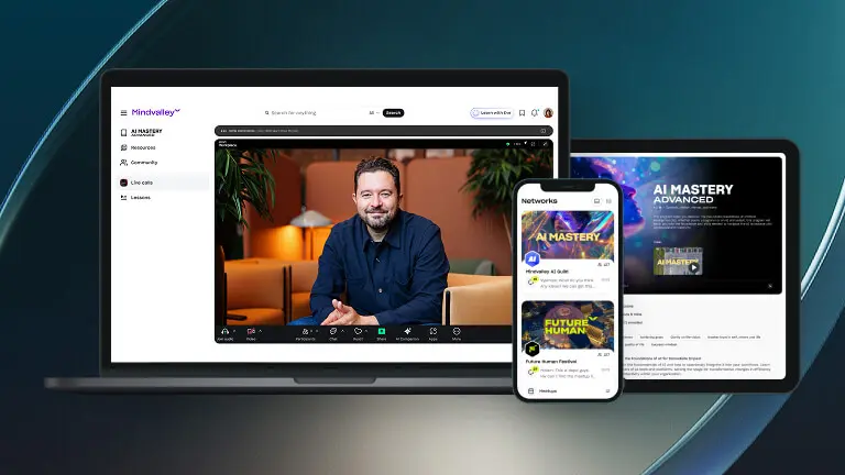 Mindvalley event stage featuring a speaker and audience with hands up