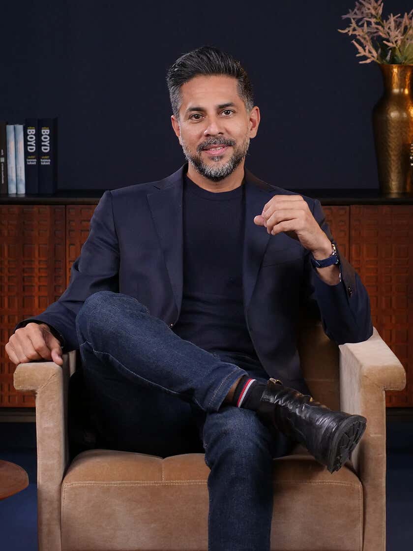 Vishen sitting on sofa talking about 6 Phase Meditation