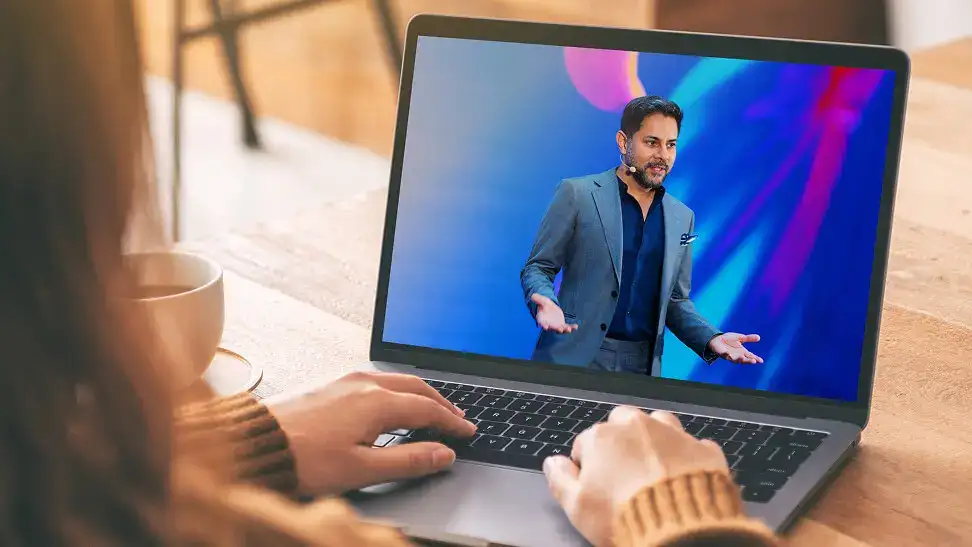 AI generated image of a lady working in front of a laptop, with flowers & fairy lights in the background